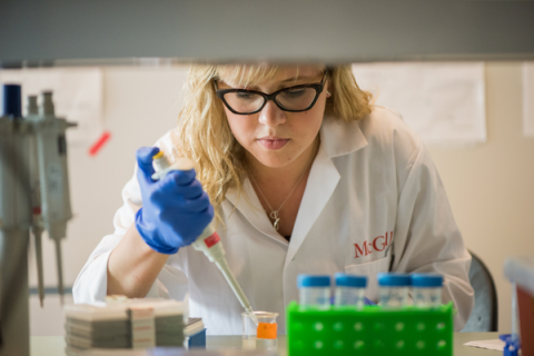 Female scientist uses instrument in lab