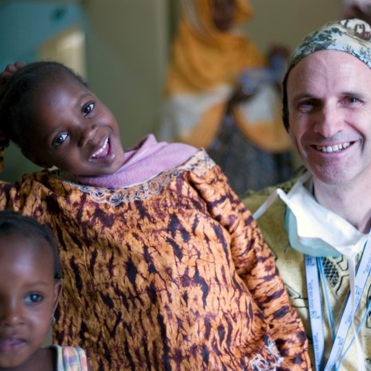 Pediatric surgeon with African children