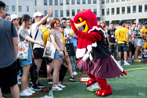 a group of students dancing with Marty, the ƽ岻 mascot